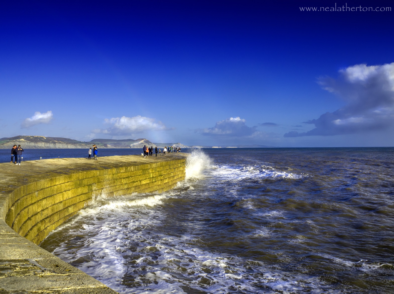 Alt="photo of waves breaking over the Cobb at Lyme Regis"